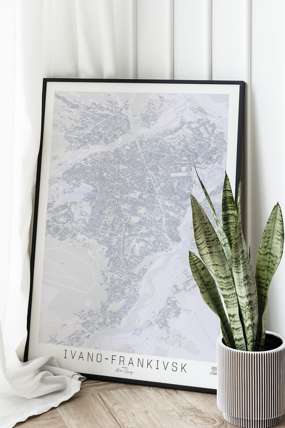 Картина міста Івано-Франківськ в рамці на фоні стіни