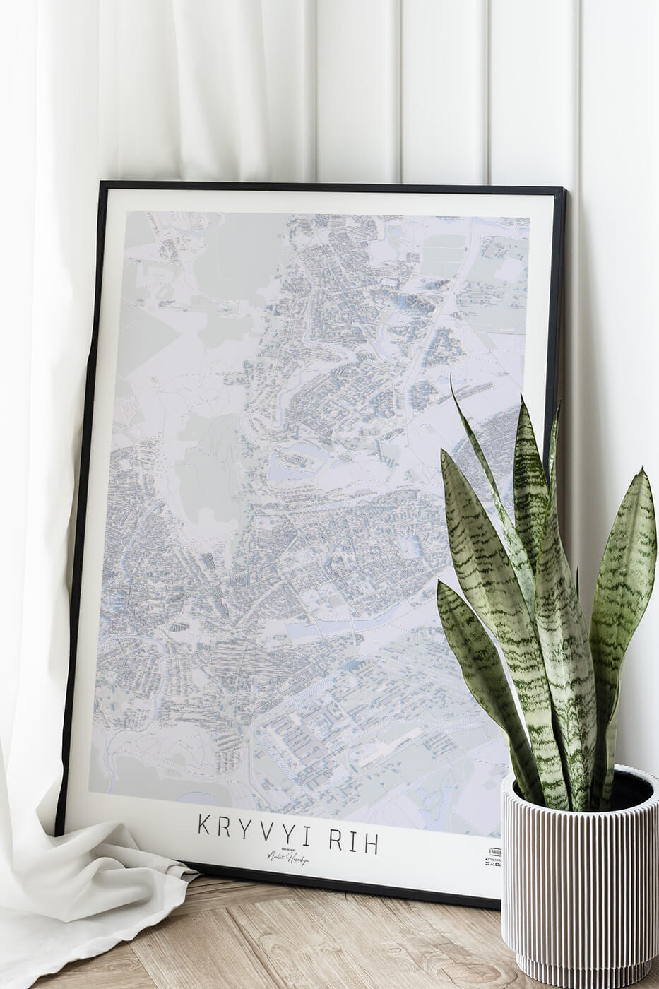 Картина міста Кривий Ріг в рамці на фоні стіни