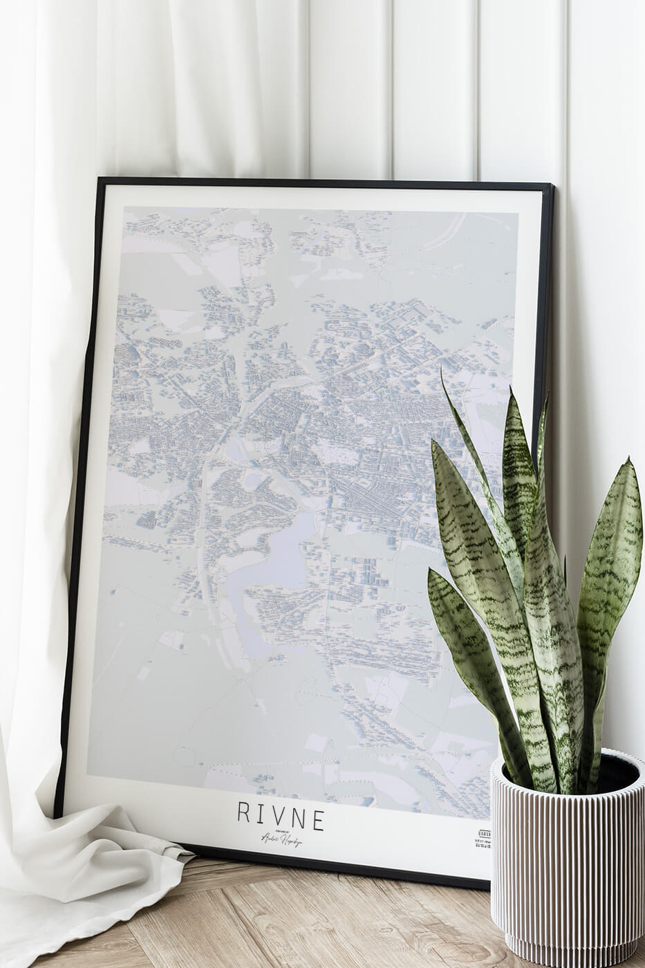 Картина міста Рівне в рамці на фоні стіни